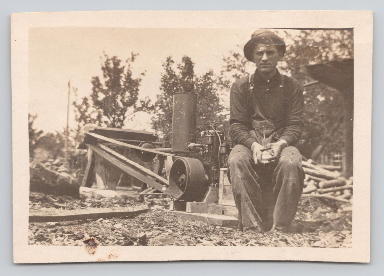 RPPC Man Sitting on Saw Mill Holding Oil Can 3.5x2.5 TRIMMED Real Photo Postcard