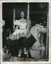 1957 Press Photo Gogi Grant astride a merry-go-round in 